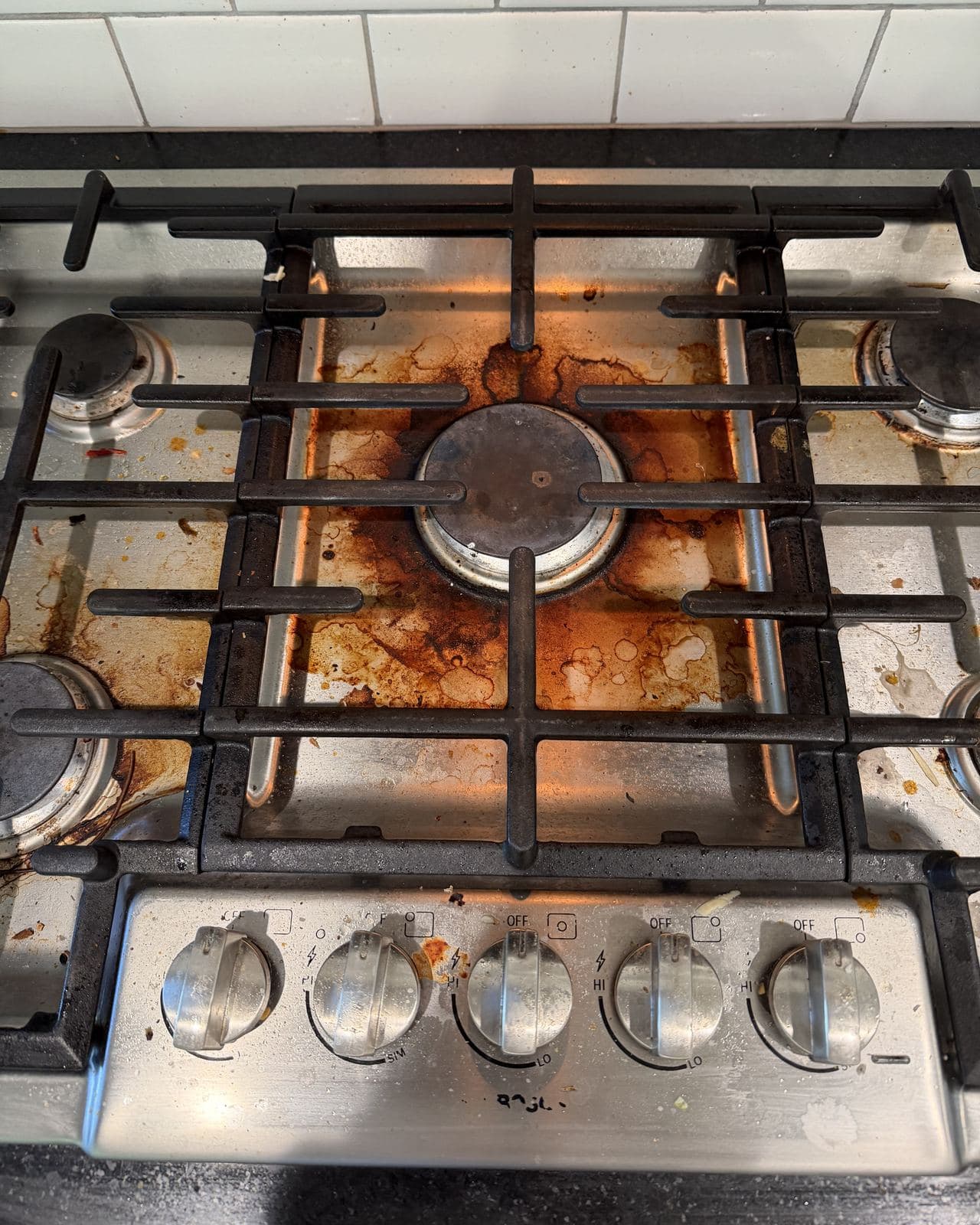 Deep clean — gas cooktop — before cleaning
